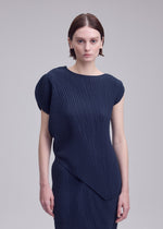 A model wears the ISSEY MIYAKE LEAF PLEATS leaf-pleats-shirt-off-white.