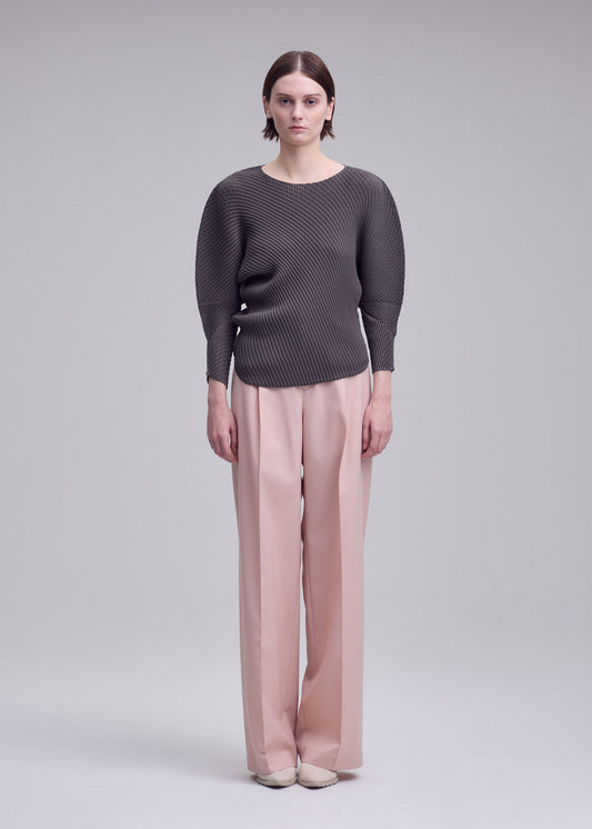 A model wears the ISSEY MIYAKE MISTY PLEATS shirt.
