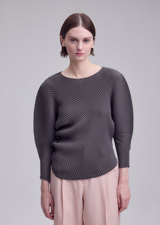 A model wears the ISSEY MIYAKE MISTY PLEATS shirt.