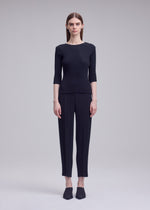 A model wears the ISSEY MIYAKE RHOMBUS PLEATS rhombus-pleats-shirt-dark-green-1.