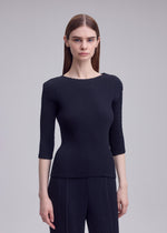 A model wears the ISSEY MIYAKE RHOMBUS PLEATS rhombus-pleats-shirt-dark-green-1.