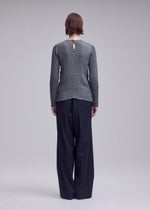 A model wears the ISSEY MIYAKE SUEDE LIKE PLEATS shirt.