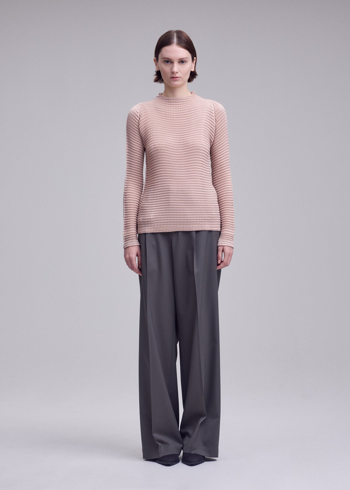 A model wears the ISSEY MIYAKE SUEDE LIKE PLEATS suede-like-pleats-shirt-grey-1.