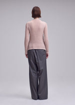 A model wears the ISSEY MIYAKE SUEDE LIKE PLEATS shirt.