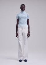 A model wears the ISSEY MIYAKE CHIFFON TWIST 1 chiffon-twist-1-shirt-light-blue-1.