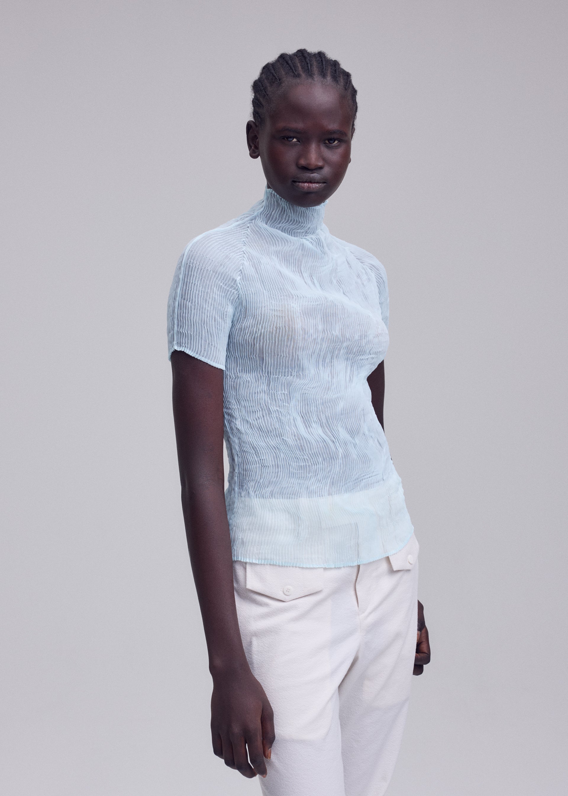 A model wears the ISSEY MIYAKE CHIFFON TWIST 1 chiffon-twist-1-shirt-light-blue-1.