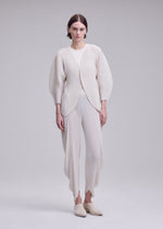 A model wears the ISSEY MIYAKE LEAF PLEATS leaf-pleats-cardigan-off-white.