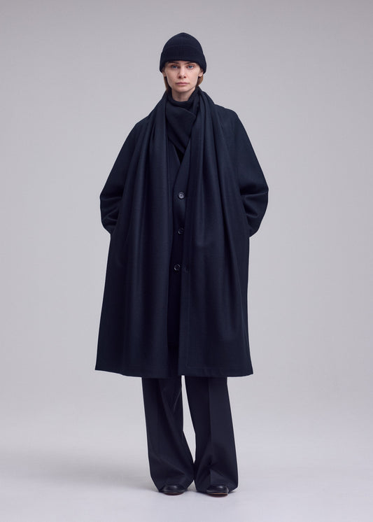 A model wears the ISSEY MIYAKE MANNER coat.