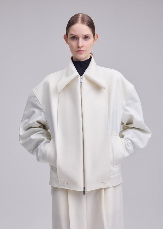 A model wears the ISSEY MIYAKE SHELL blouson.