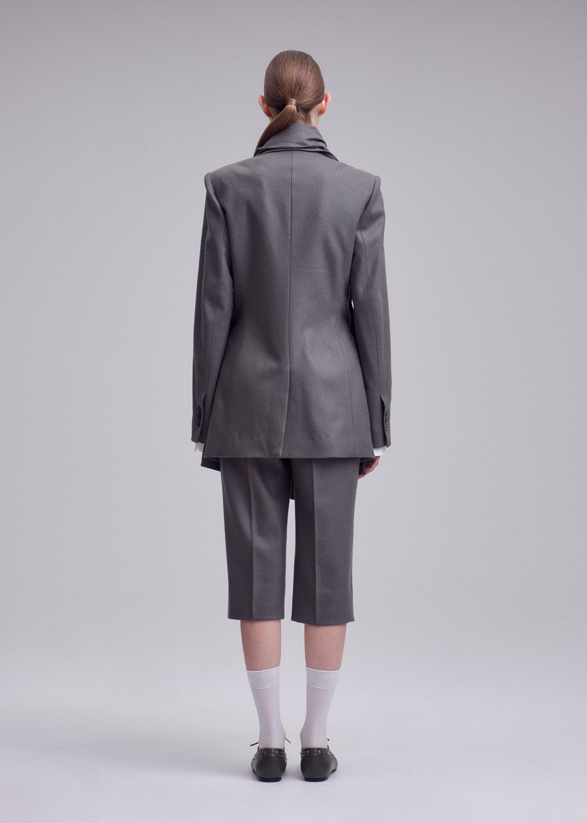 A model wears the ISSEY MIYAKE MANNER jacket.