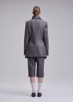 A model wears the ISSEY MIYAKE MANNER jacket.