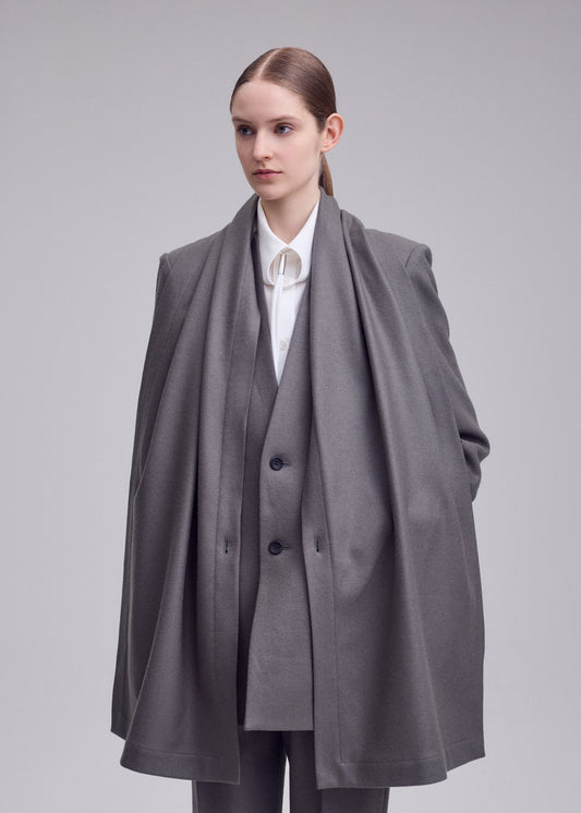 A model wears the ISSEY MIYAKE MANNER jacket.