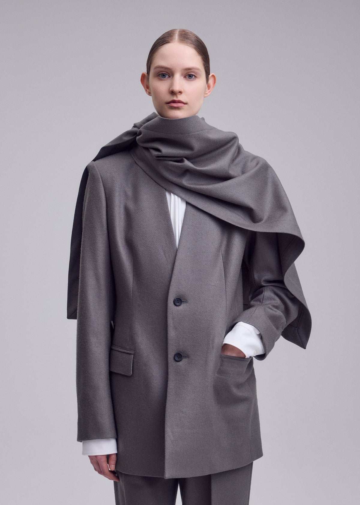 A model wears the ISSEY MIYAKE MANNER jacket.