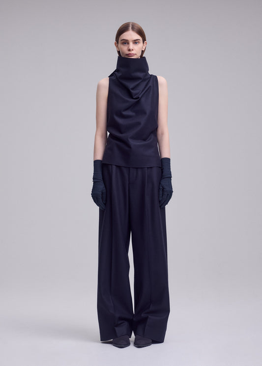 A model wears the ISSEY MIYAKE SHELL shirt.