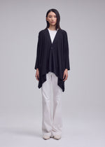 A model wears the ISSEY MIYAKE DRAPE JERSEY-68 drape-jersey-68-cardigan-black-1.