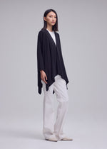 A model wears the ISSEY MIYAKE DRAPE JERSEY-68 drape-jersey-68-cardigan-off-white.