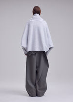 A model wears the ISSEY MIYAKE WOOLEN GRANITE coat.