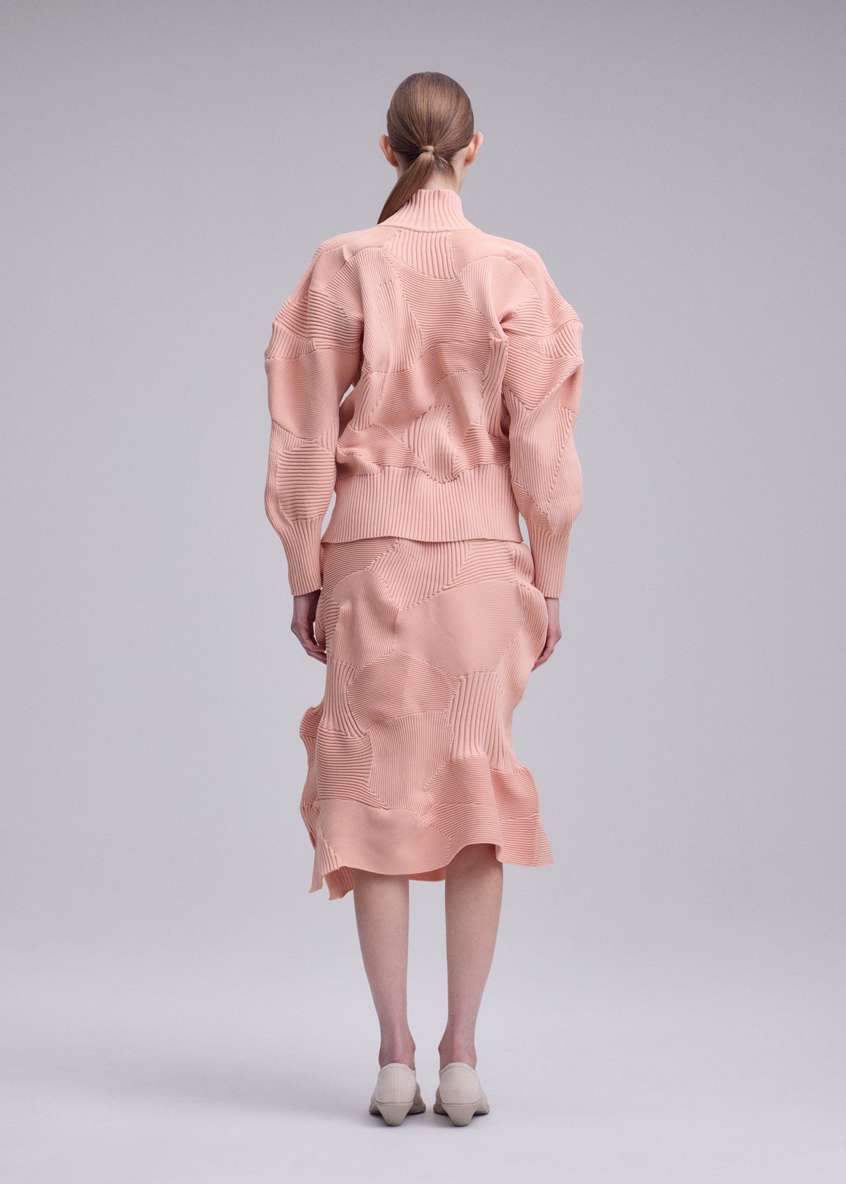 A model wears the ISSEY MIYAKE KONE KONE jacket.