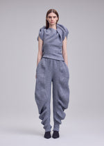 A model wears the ISSEY MIYAKE FOUND STONE found-stone-trousers-black.