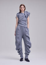 A model wears the ISSEY MIYAKE FOUND STONE found-stone-trousers-black.