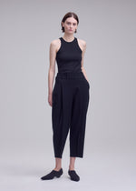 A model wears the ISSEY MIYAKE CAMPAGNE campagne-trousers-black-16.