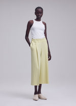 A model wears the ISSEY MIYAKE CAMPAGNE campagne-trousers-dark-navy-1.