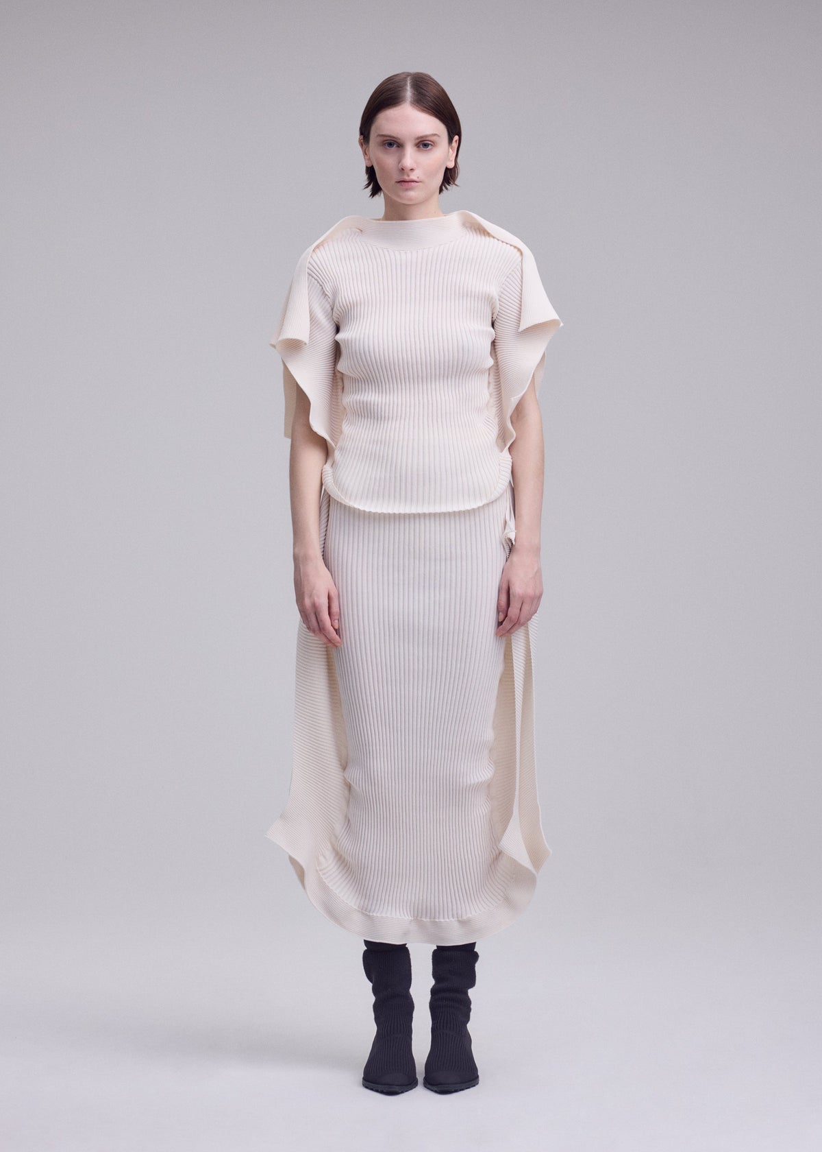 A model wears the ISSEY MIYAKE PRANCE prance-skirt-ivory.