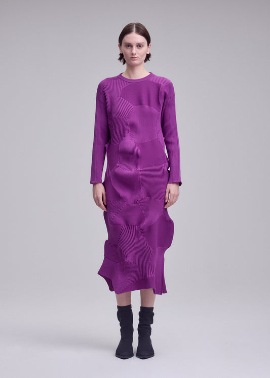 A model wears the ISSEY MIYAKE KONE KONE dress.