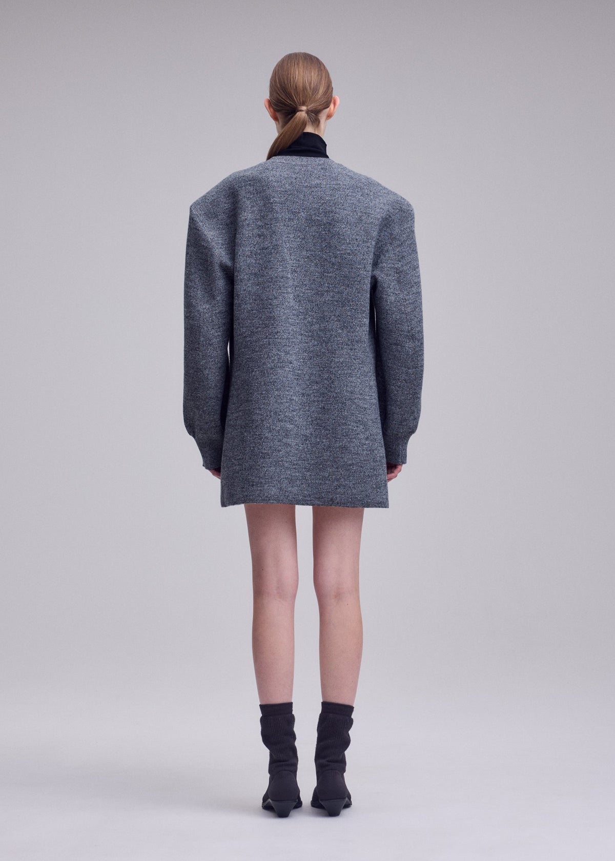 A model wears the ISSEY MIYAKE HANDSOME KNIT dress.