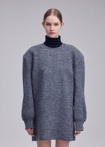 A model wears the ISSEY MIYAKE HANDSOME KNIT dress.