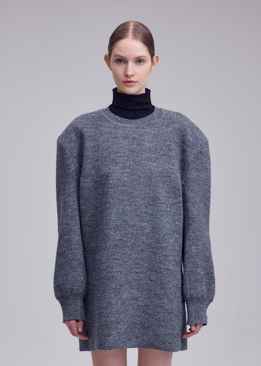 A model wears the ISSEY MIYAKE HANDSOME KNIT dress.