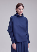 A model wears the ISSEY MIYAKE CAMPAGNE campagne-top-black-10.
