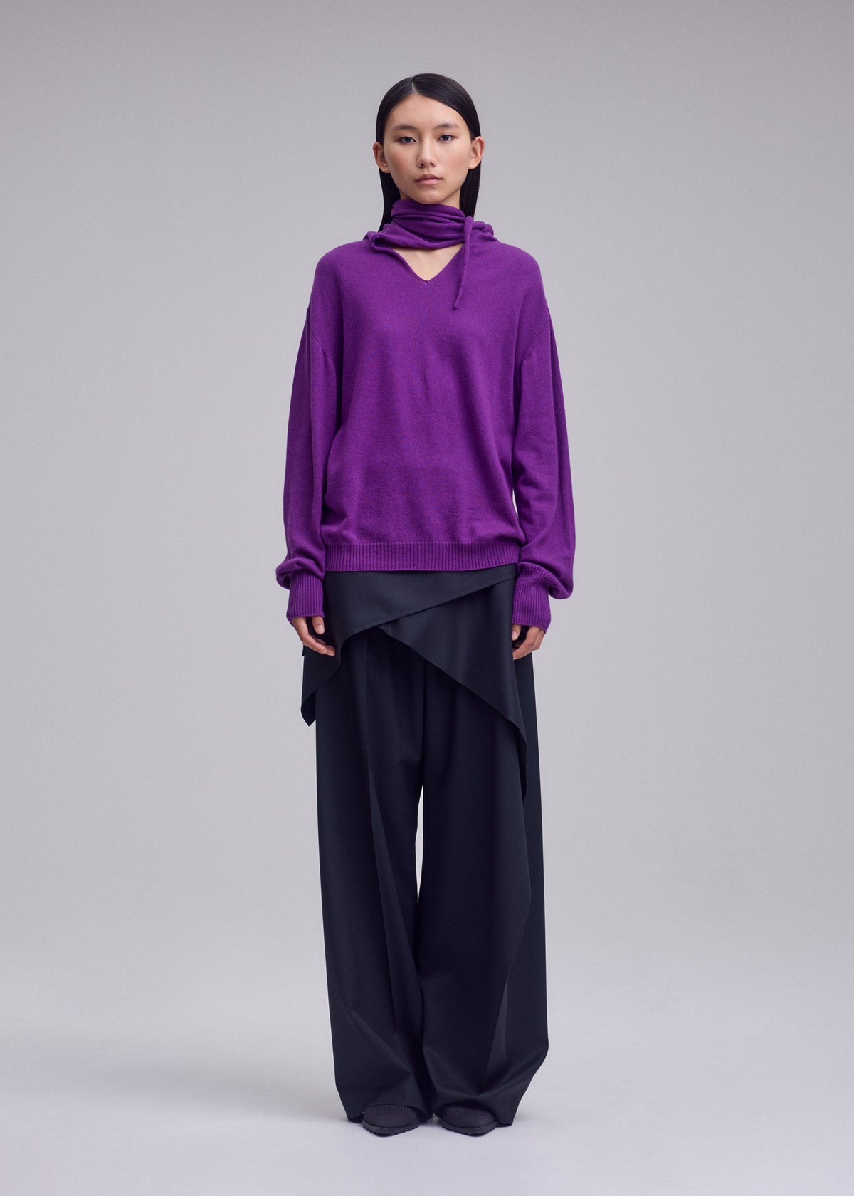 A model wears the ISSEY MIYAKE SILK CASHMERE KNIT top.