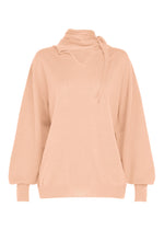 A product shot of the ISSEY MIYAKE SILK CASHMERE KNIT top in light pink.