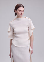 A model wears the ISSEY MIYAKE PRANCE prance-top-ivory.