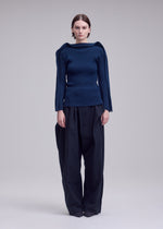 A model wears the ISSEY MIYAKE PRANCE prance-top-ivory-1.