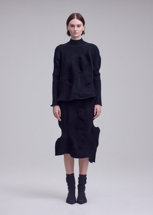 A model wears the ISSEY MIYAKE KONE KONE top.