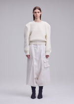 A model wears the ISSEY MIYAKE HANDSOME KNIT handsome-knit-top-grey.