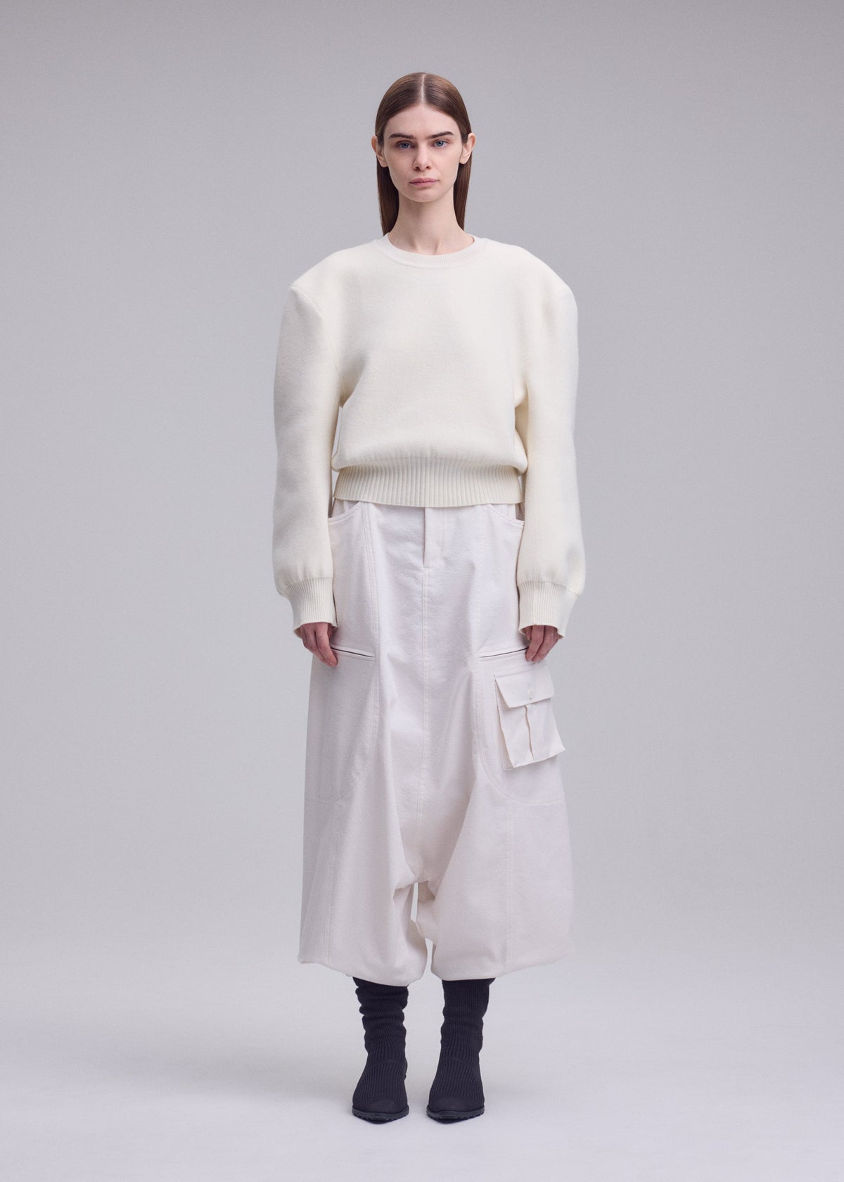 A model wears the ISSEY MIYAKE HANDSOME KNIT handsome-knit-top-black.