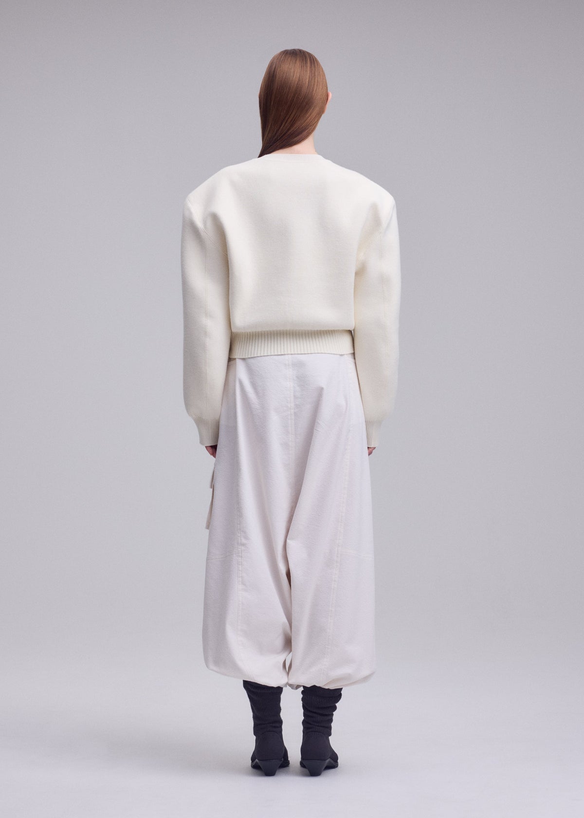 A model wears the ISSEY MIYAKE HANDSOME KNIT top.