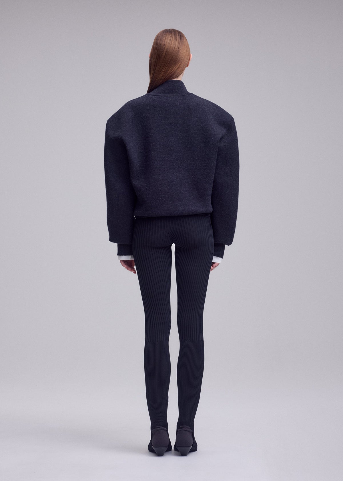 A model wears the ISSEY MIYAKE HANDSOME KNIT top.