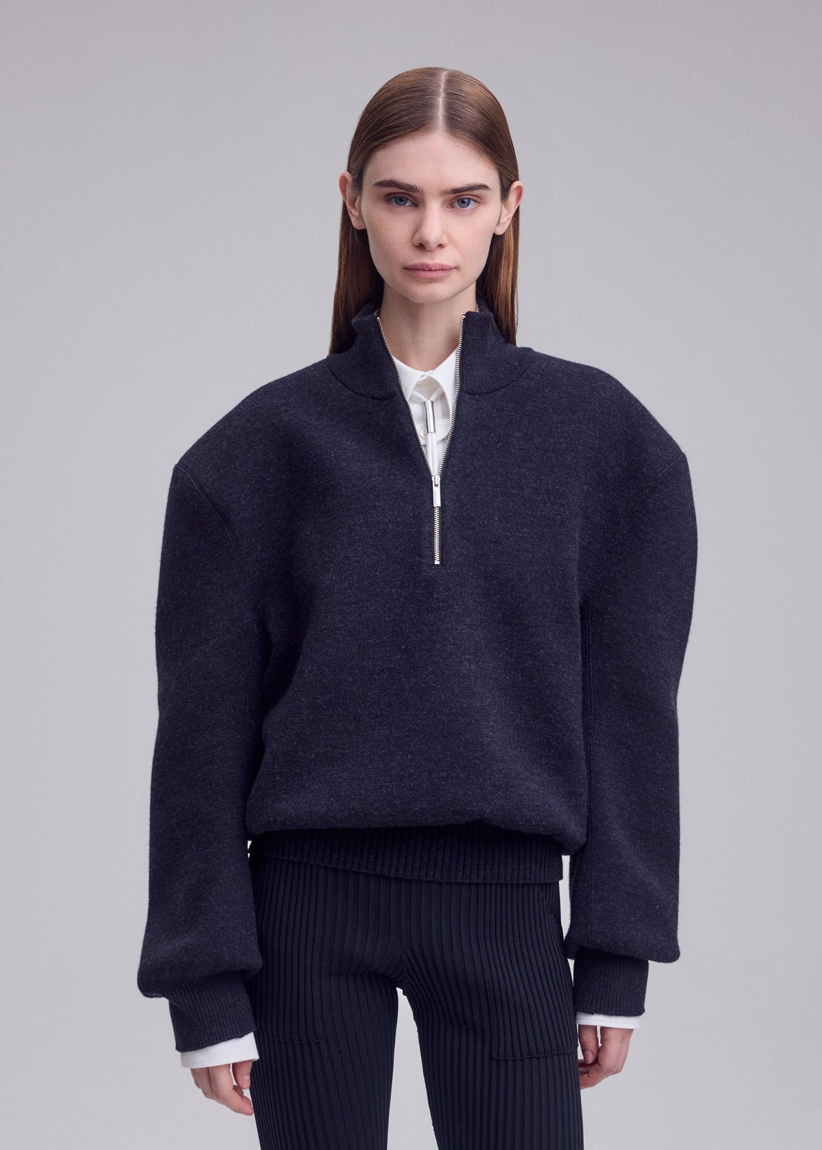 A model wears the ISSEY MIYAKE HANDSOME KNIT top.