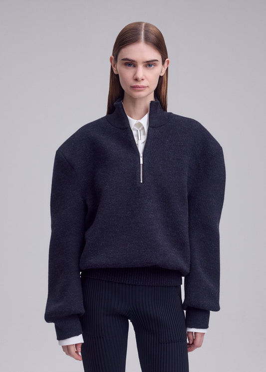 A model wears the ISSEY MIYAKE HANDSOME KNIT top.
