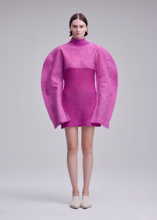A model wears the ISSEY MIYAKE PANINI PULLED panini-pulled-dress-black.