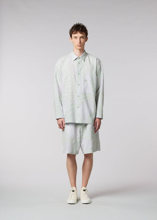 A model wears the ISSEY MIYAKE MEN SCENES shirt.