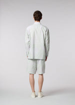 A model wears the ISSEY MIYAKE MEN SCENES shirt.