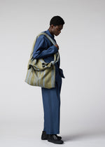 A model wears the IM Men COTTON JACQUARD BAG bag.