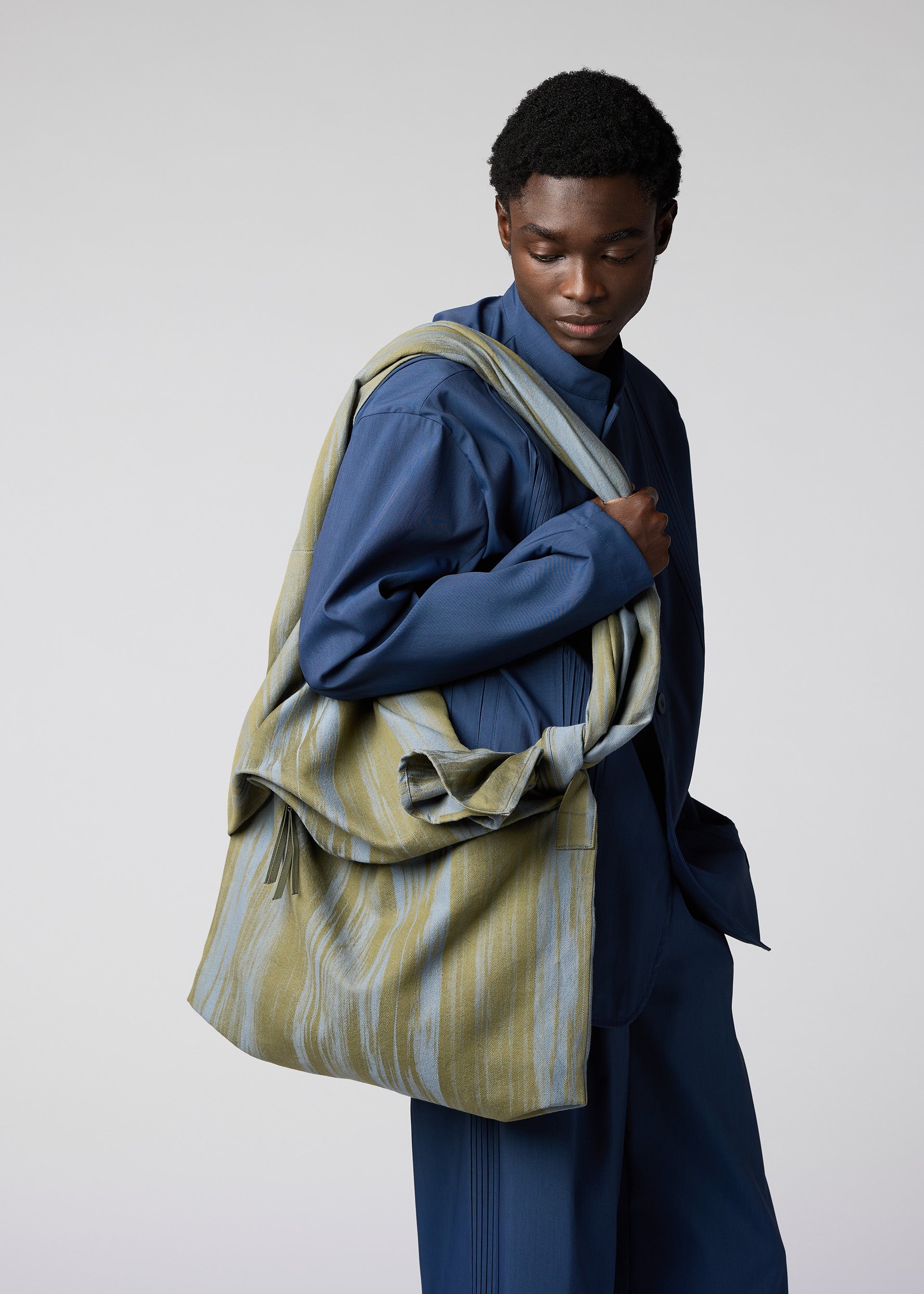 A model wears the IM Men COTTON JACQUARD BAG bag.