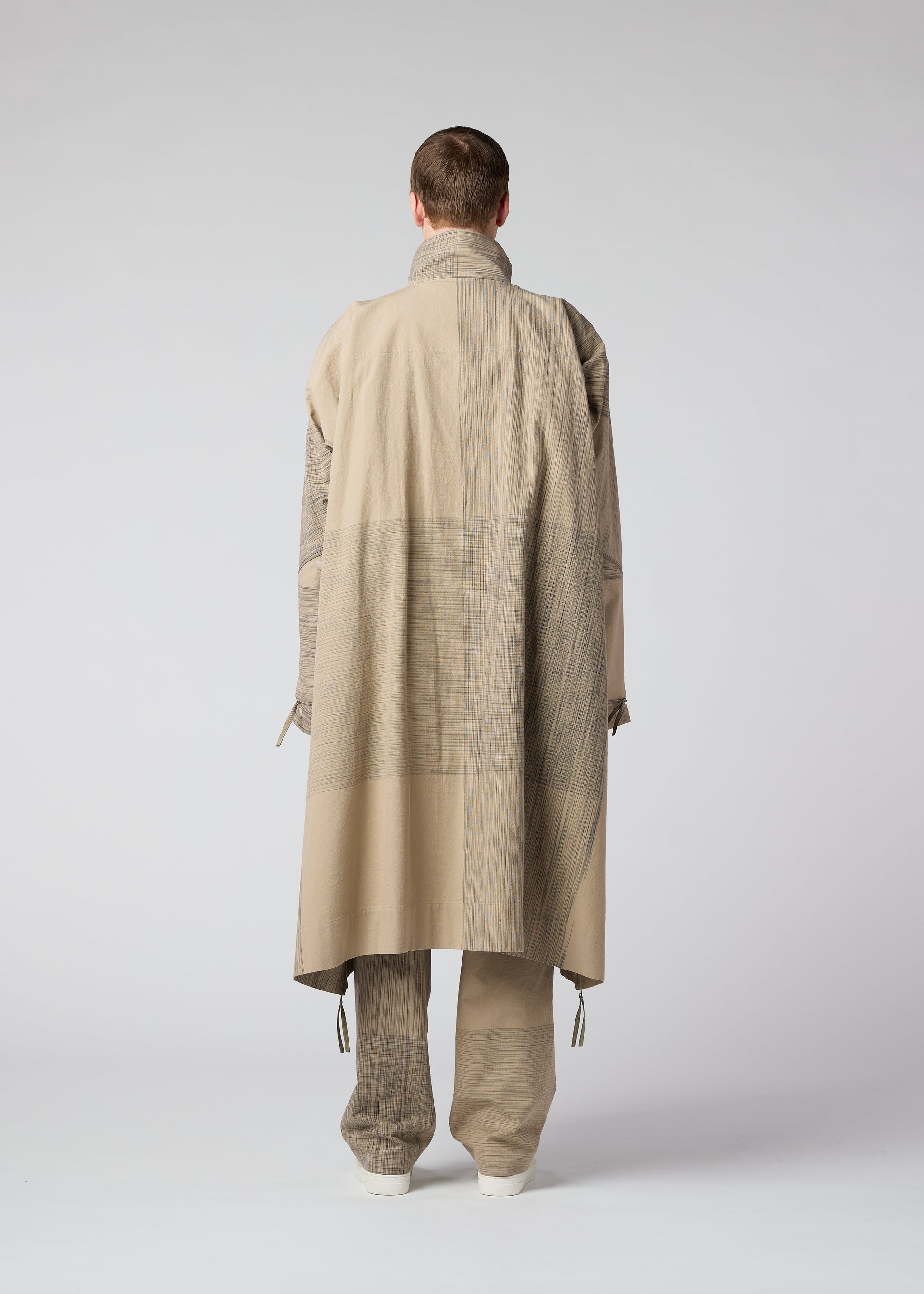 A model wears the IM MEN KASURI coat.