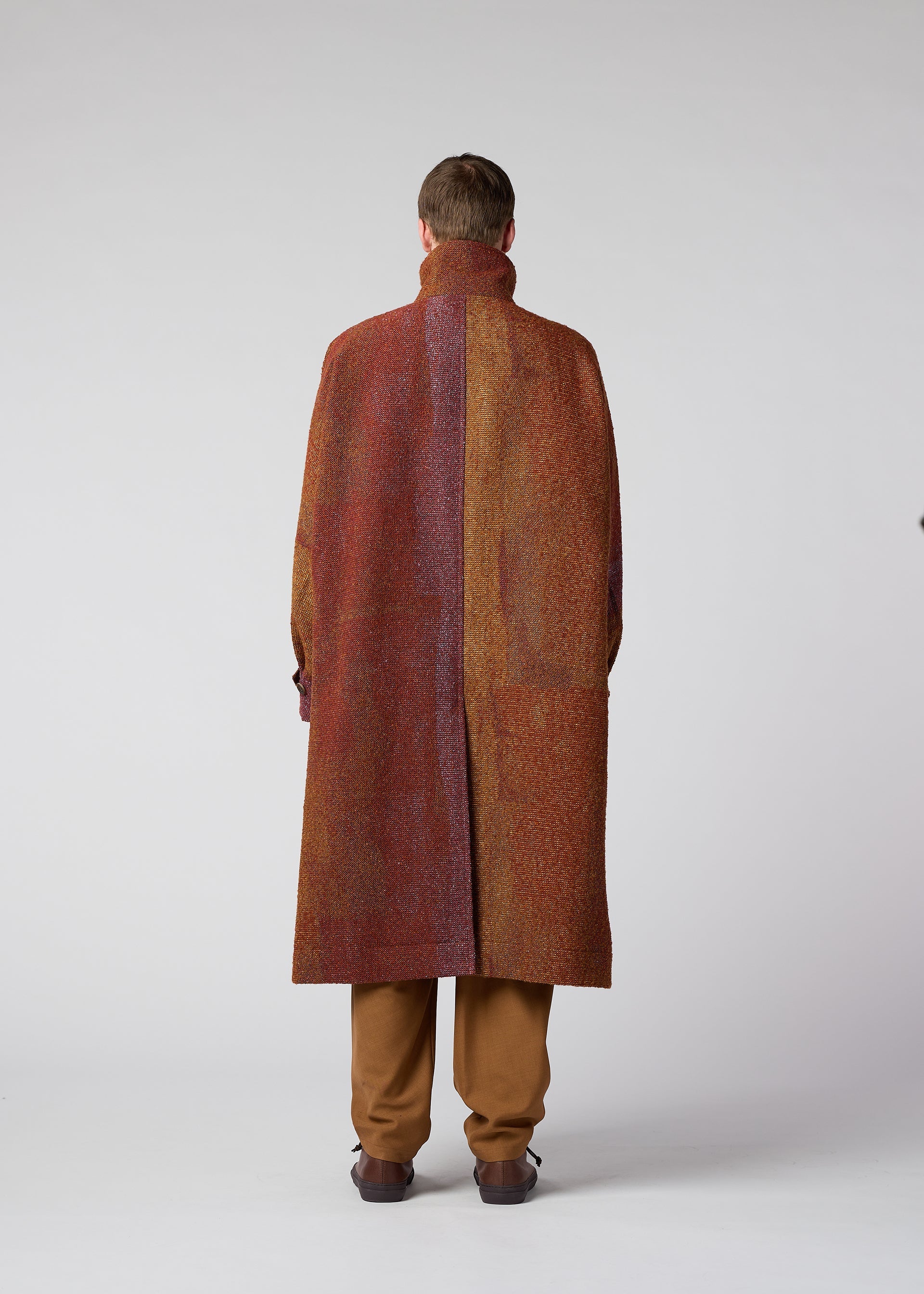 A model wears the IM MEN PAINTING JACQUARD coat.